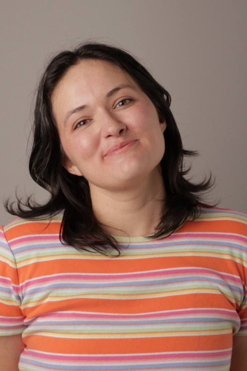 Portrait headshot of Willa Barnett in a striped tee